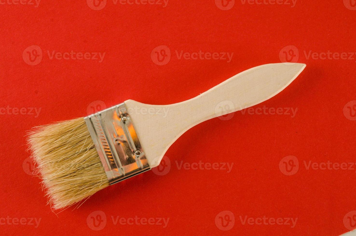 Painting brush on red background photo