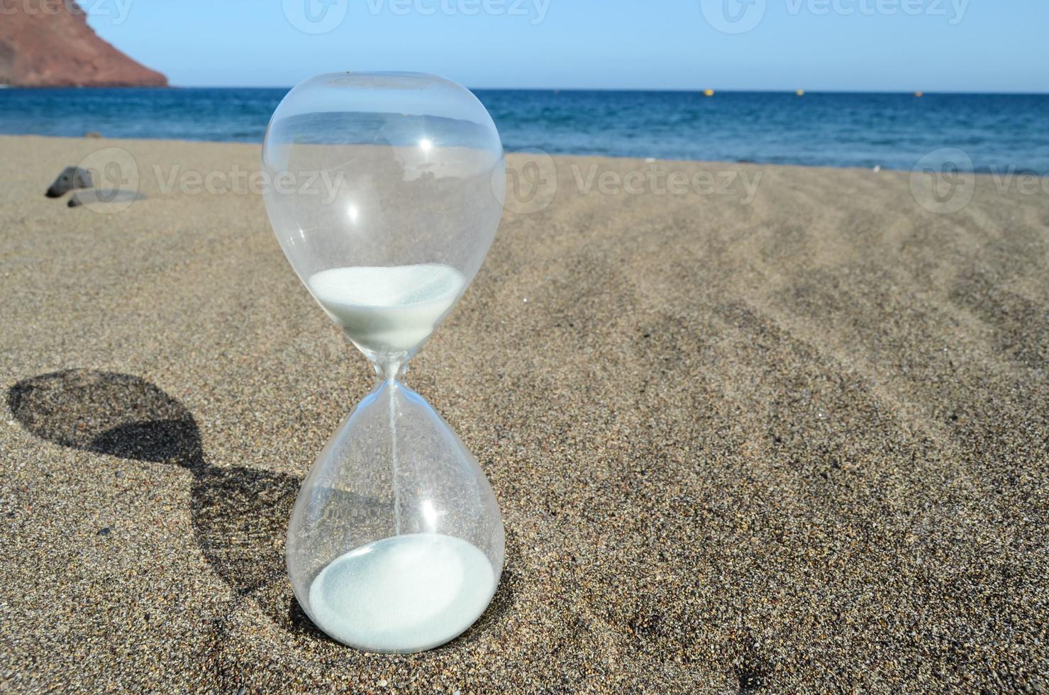 Hourglass in the sand photo