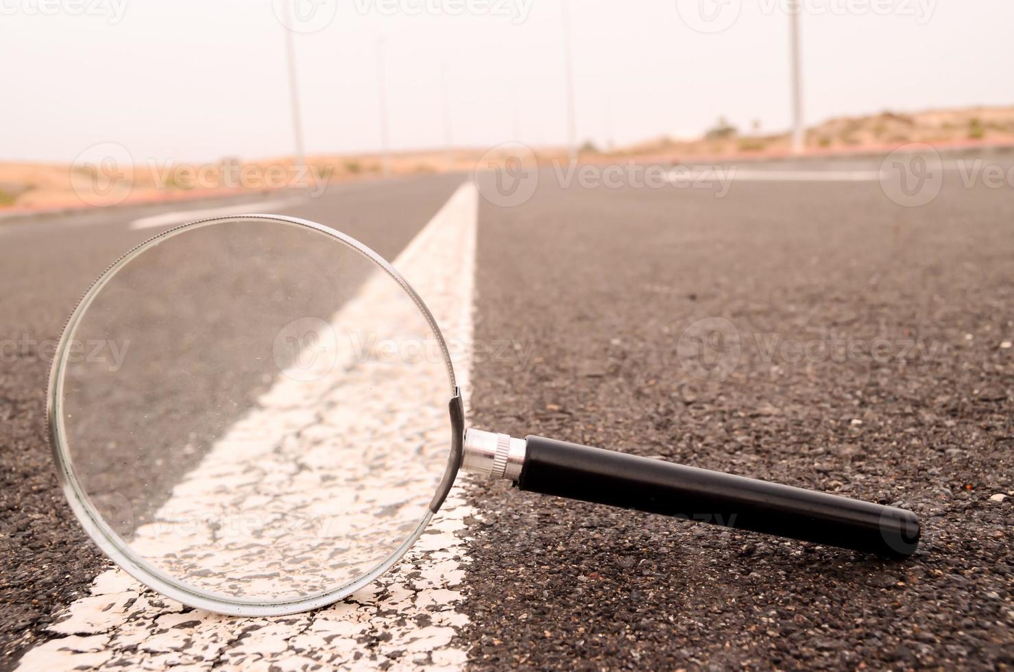 Magnifying glass on the road photo