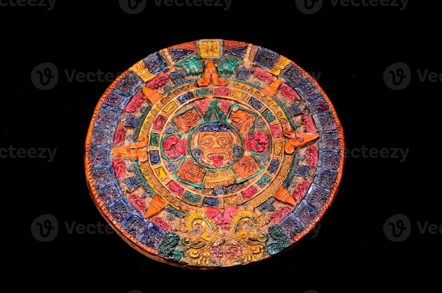 Mayan calendar on black background photo