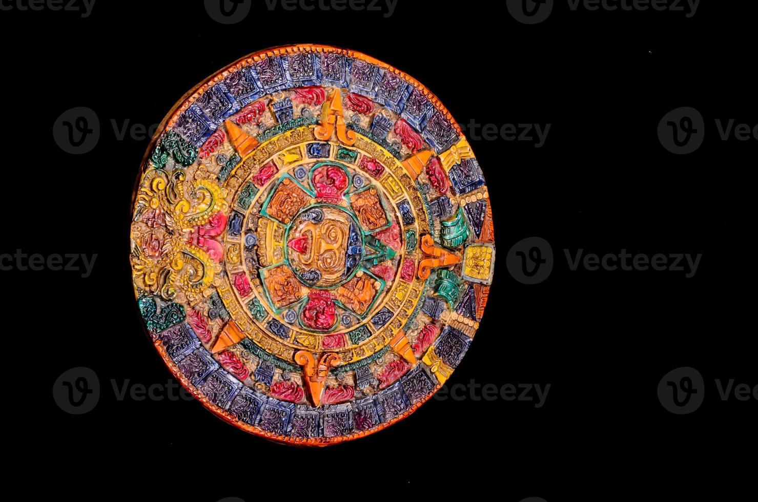 Mayan calendar on black background photo