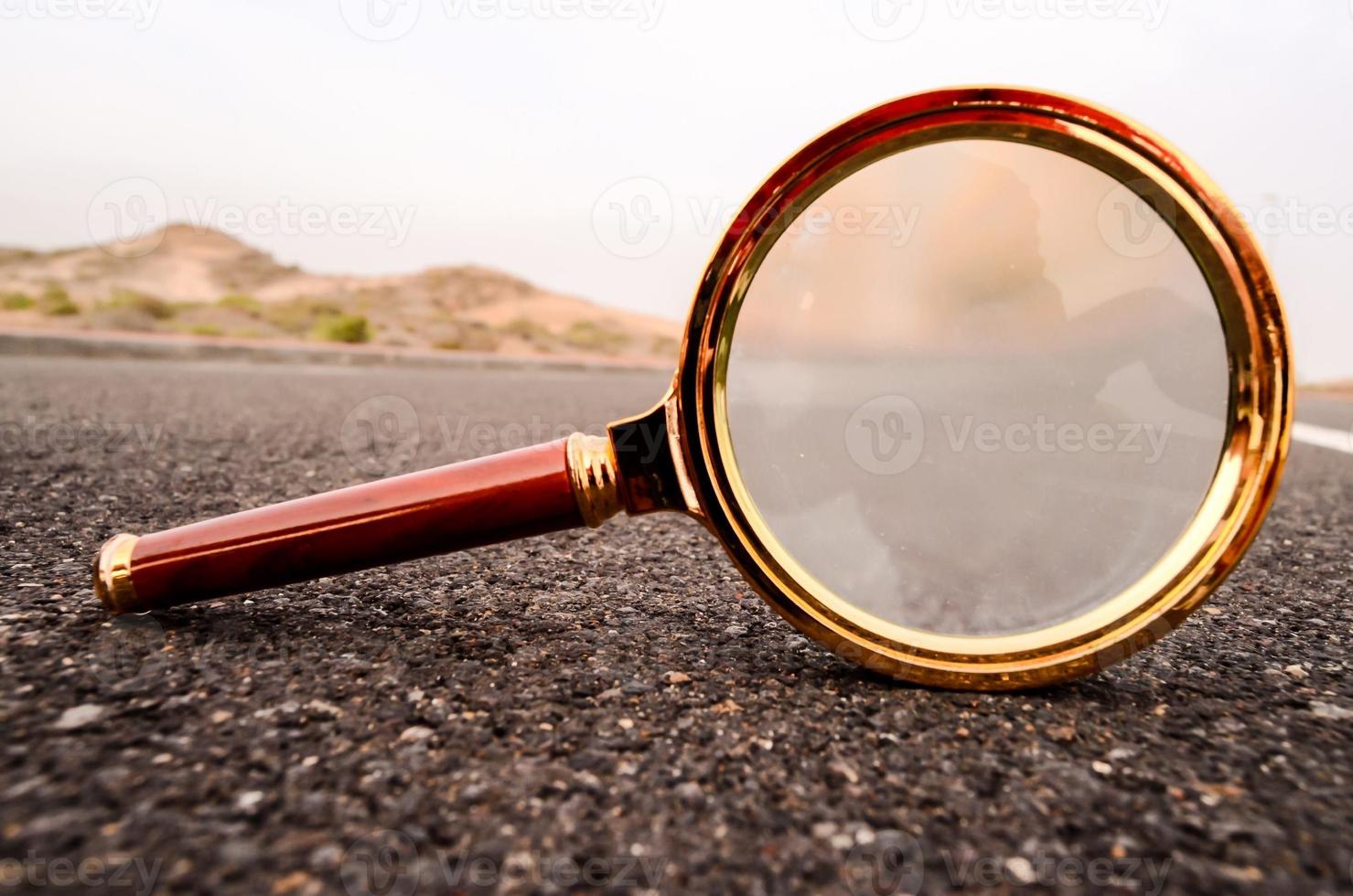 Magnifying glass on the road photo