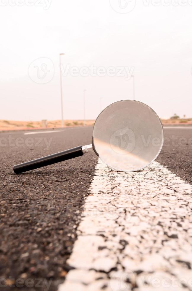Magnifying glass on the road photo
