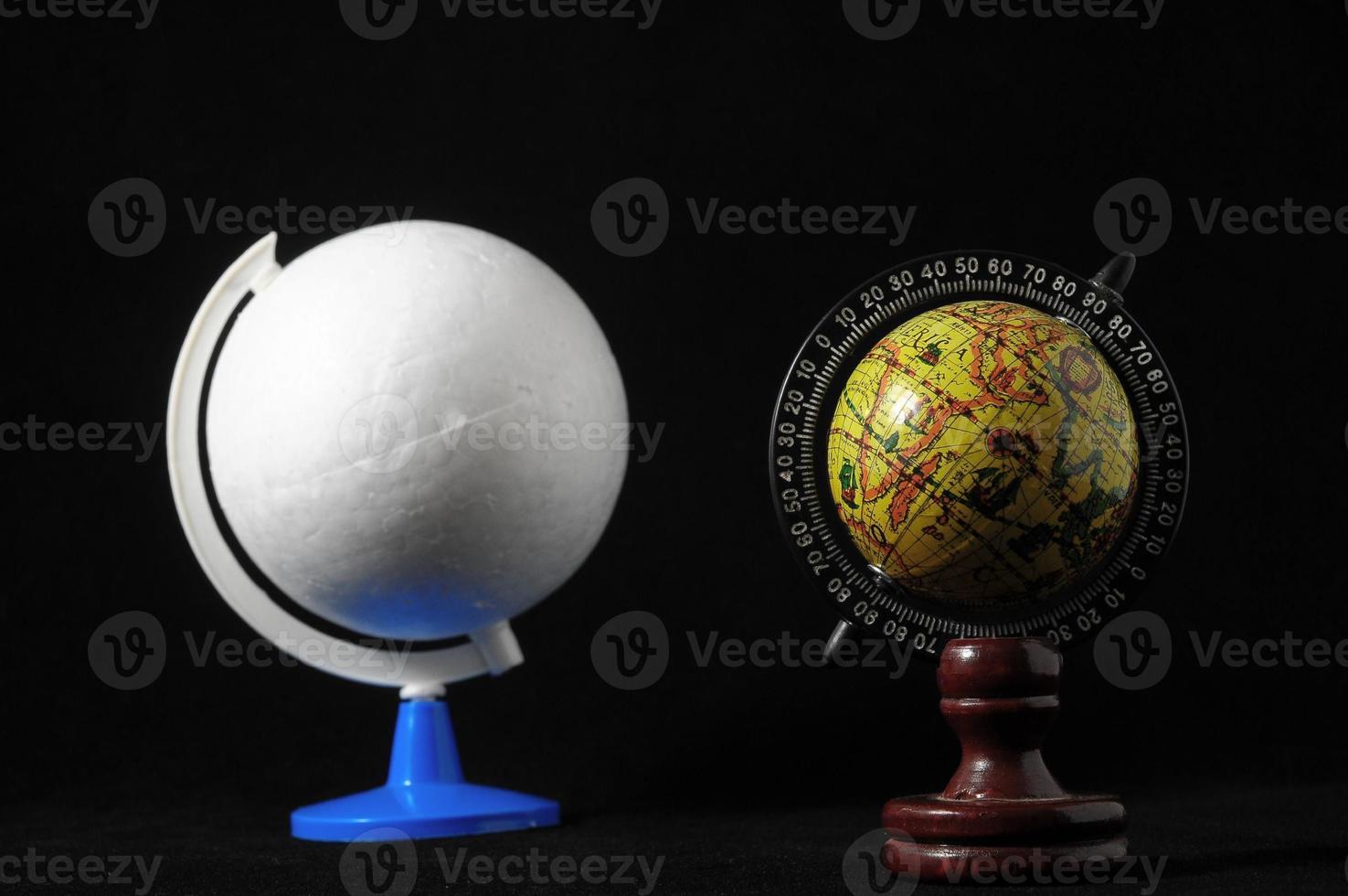 Two globes on black background photo