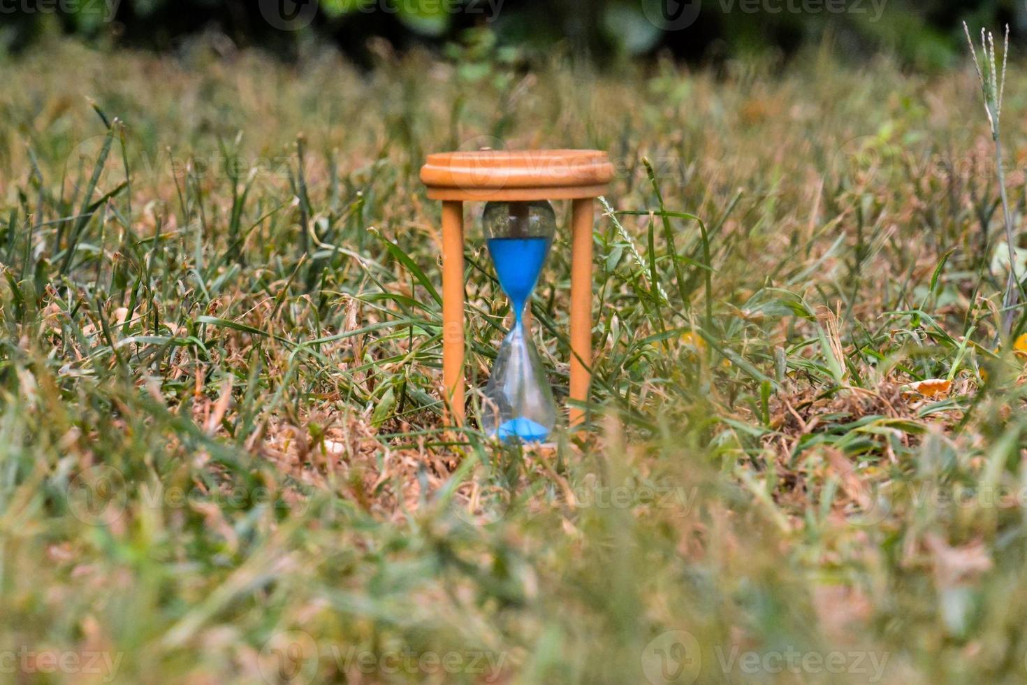 Hourglass with blue sand photo