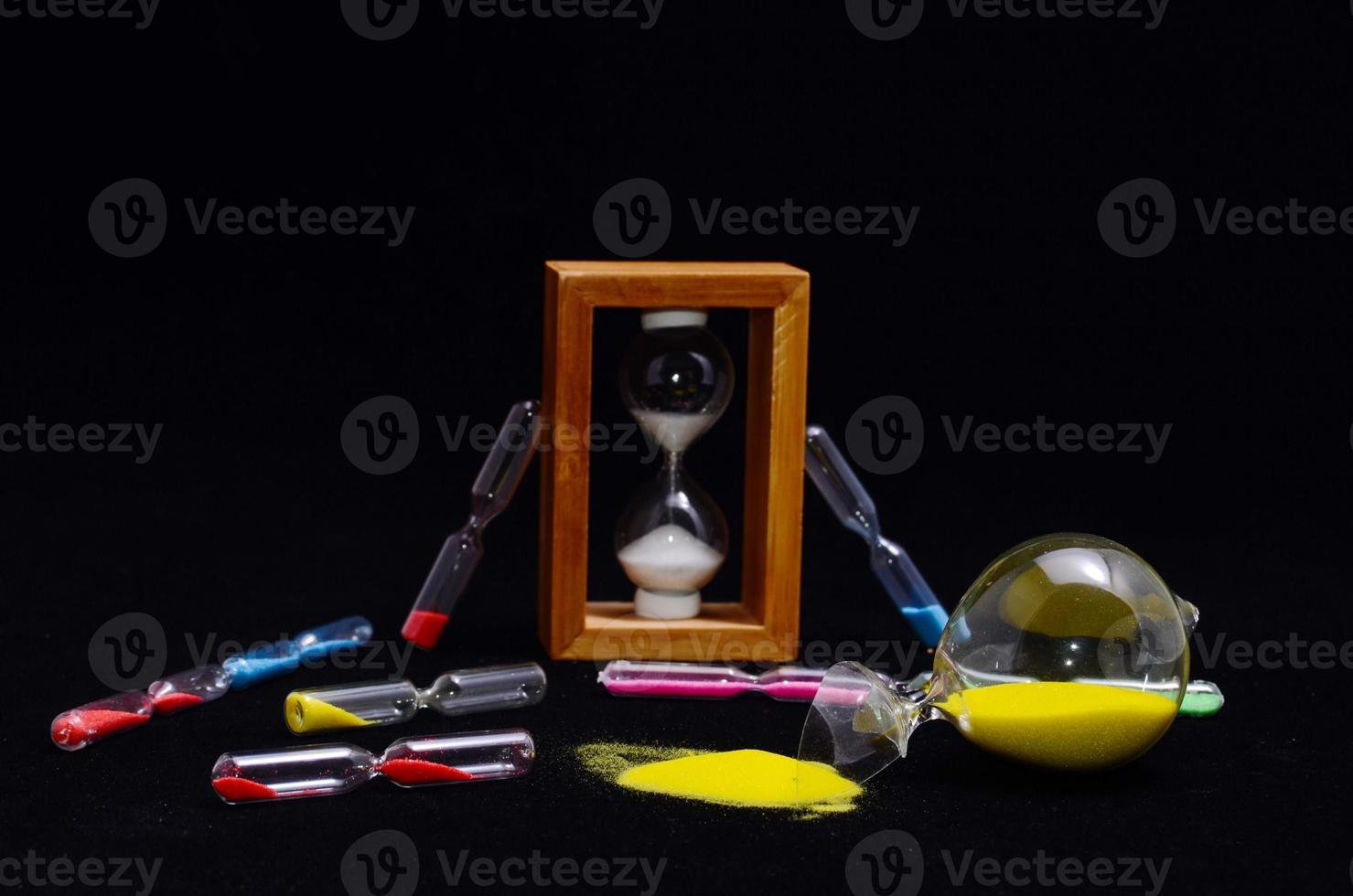 Hourglasses on black background photo