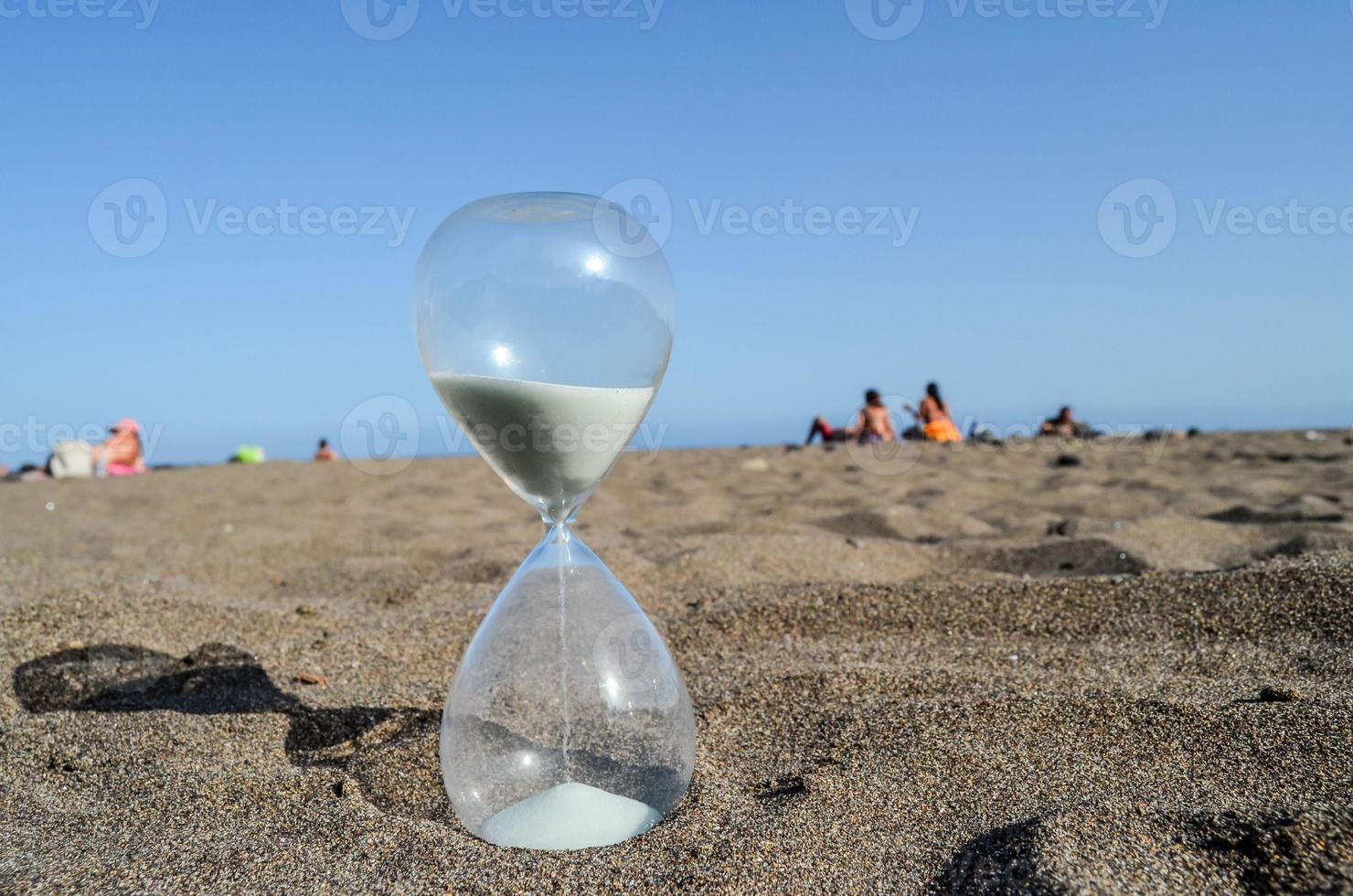 Hourglass on the sand photo