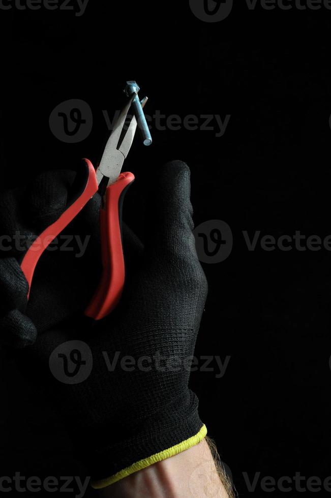 Pliers on black background photo
