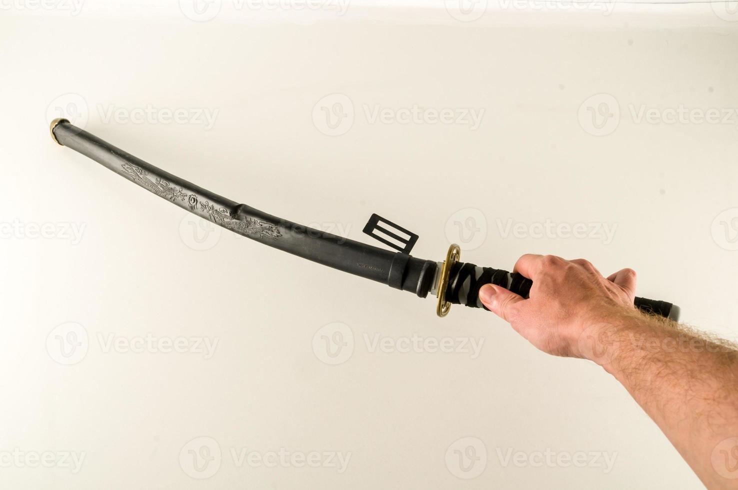 Hand holding a samurai sword photo