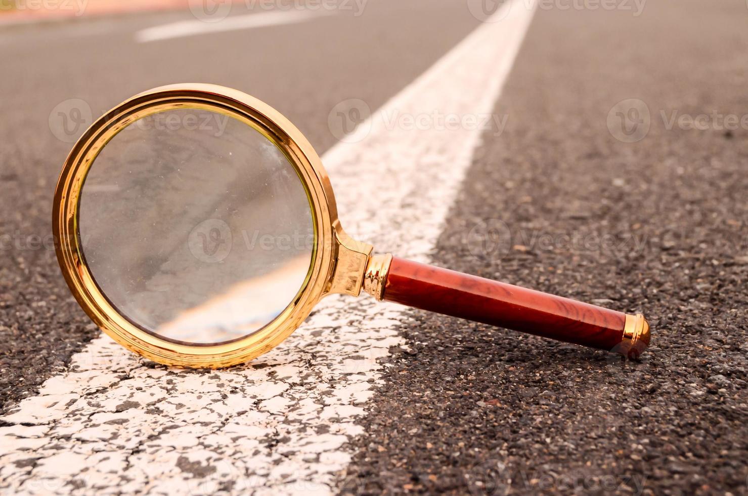 Magnifying glass on the road photo