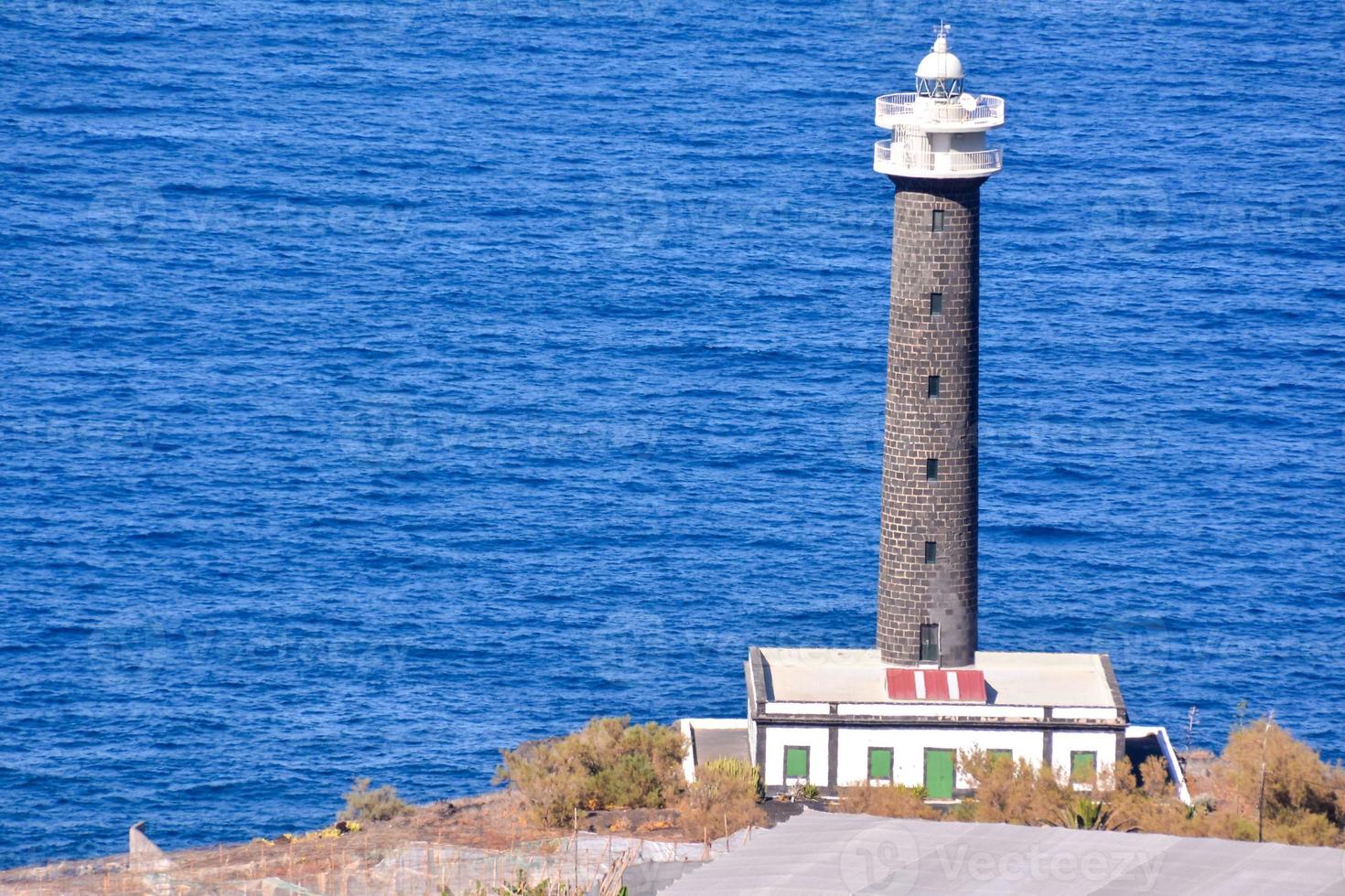 Lighthouse near the ocean photo