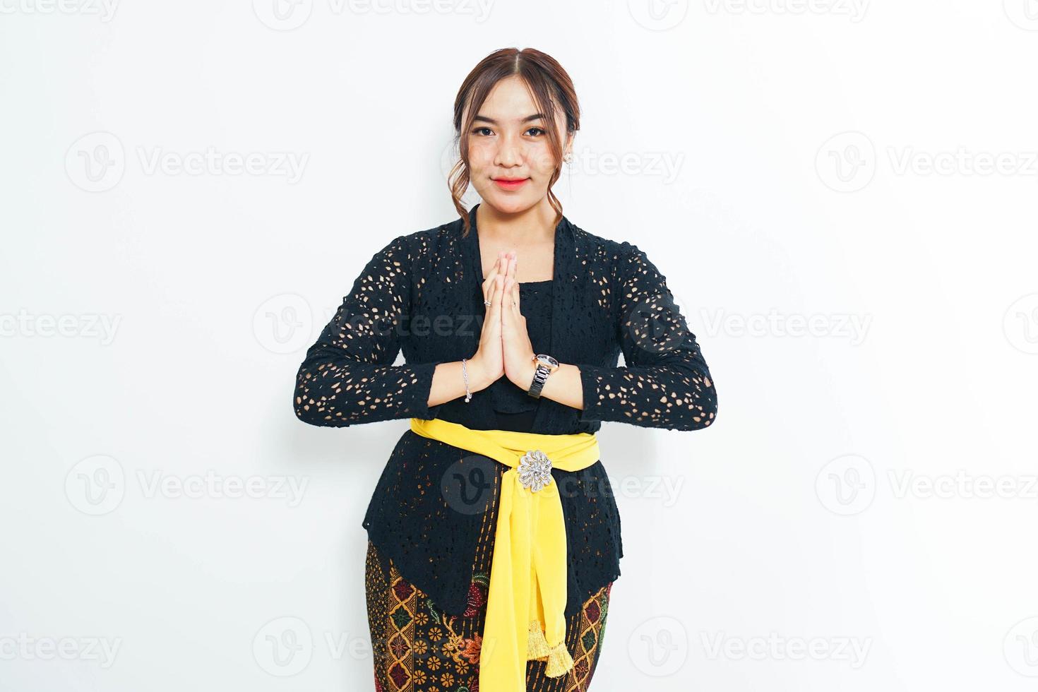 Welcoming guests with a warm Balinese smile, a woman embraces the spirit of  hospitality on the Island of the Gods. photo