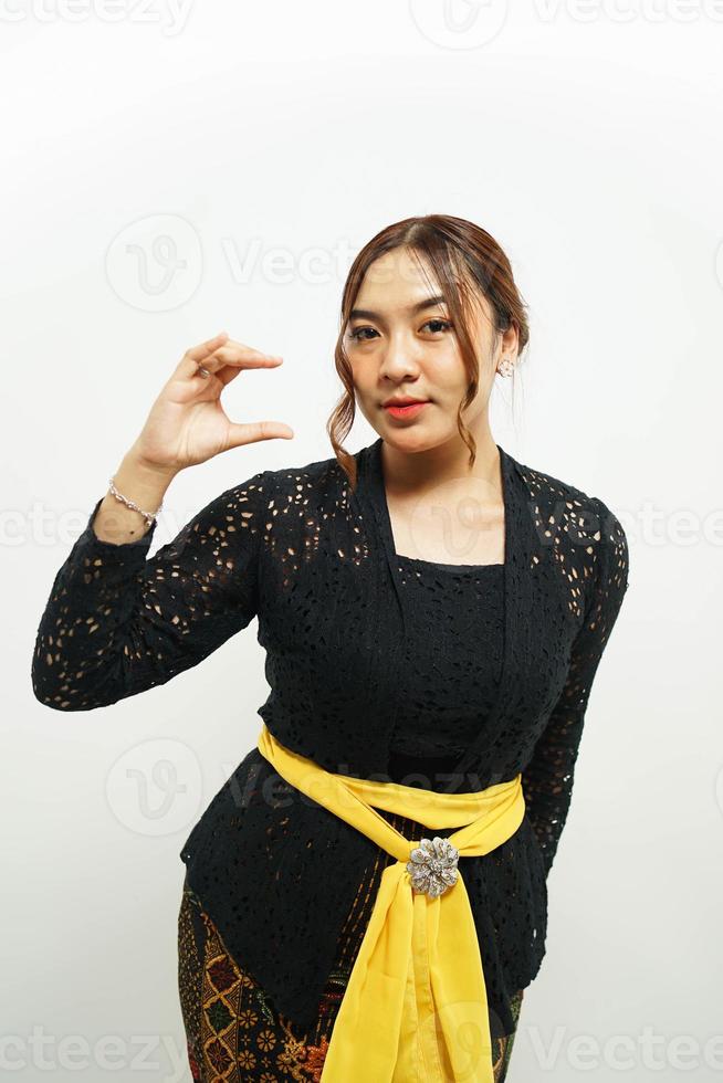 Balinese woman presents her offerings with a confident hand photo