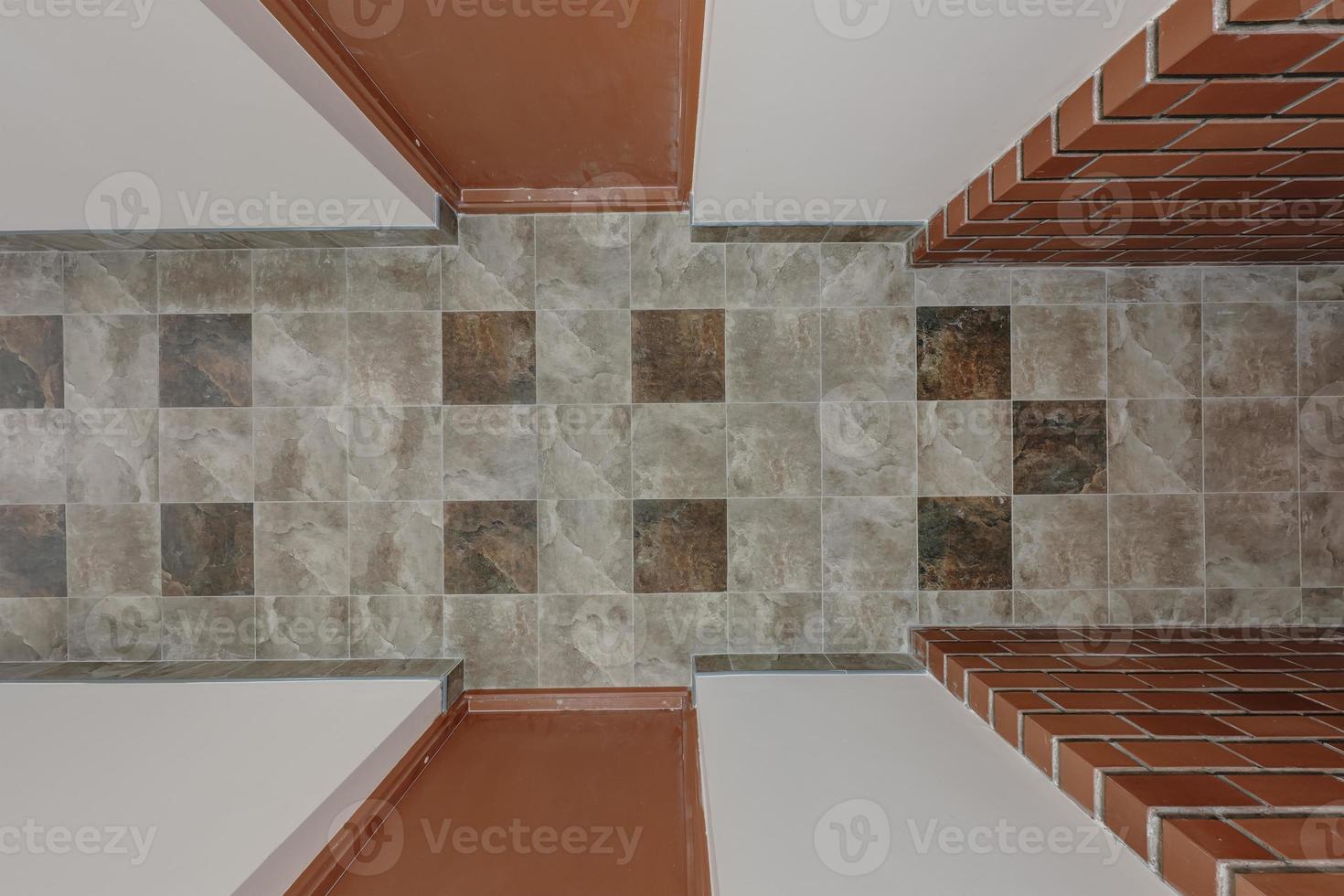 stone and ceramic floor tiles texture in corridor, view from above