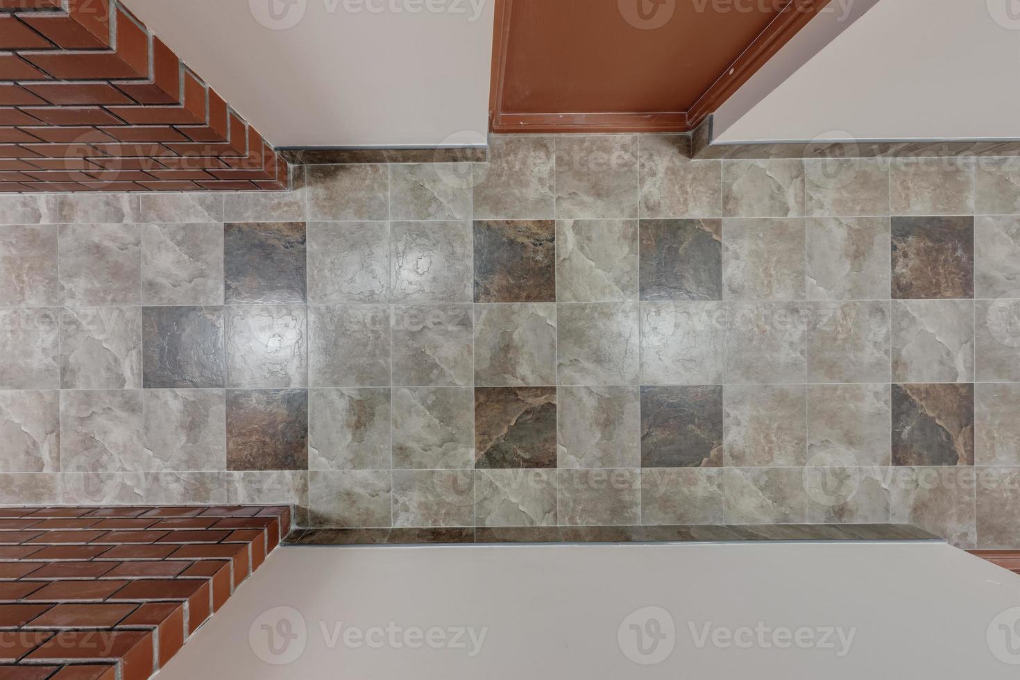 stone and ceramic floor tiles texture in corridor, view from above