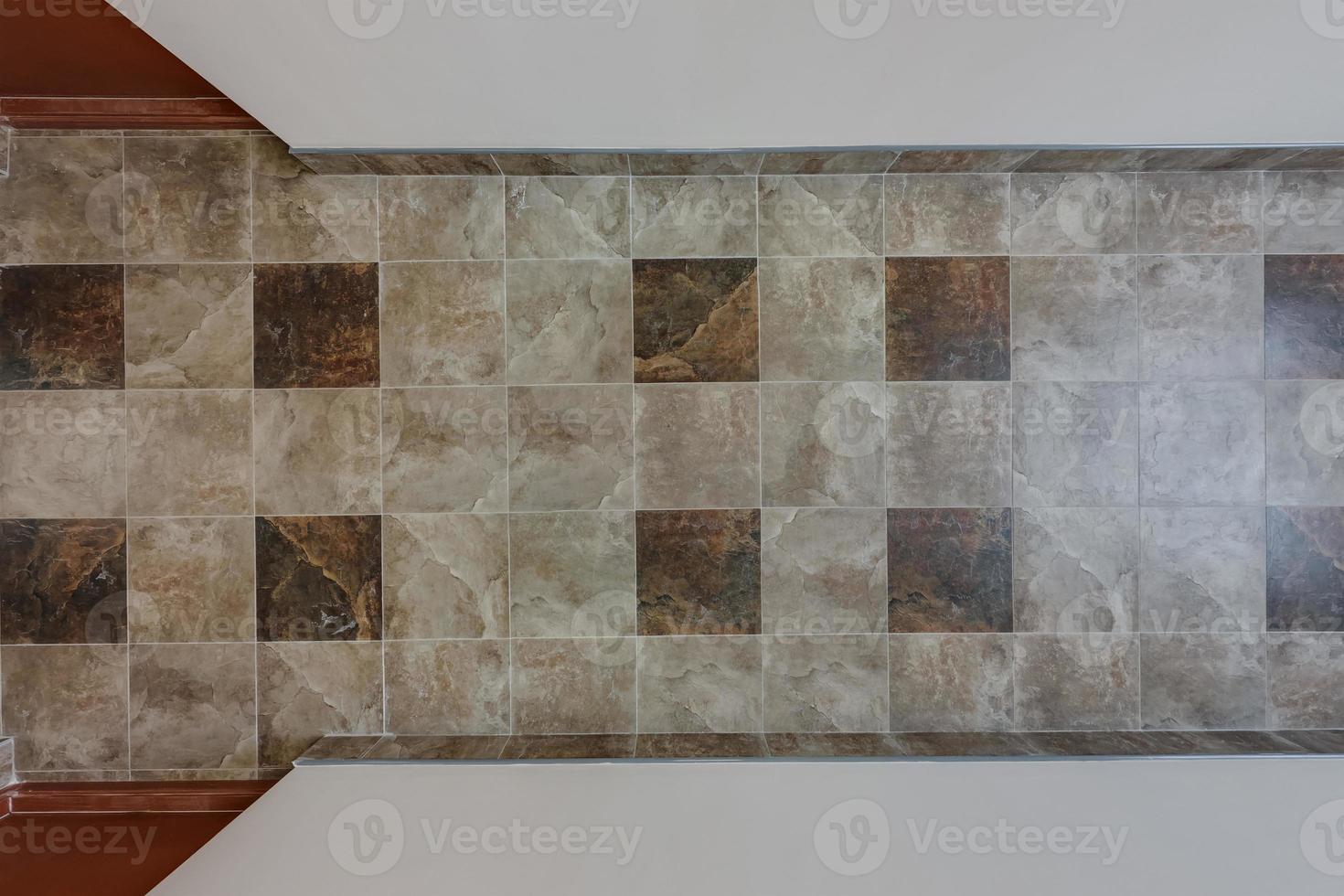 stone and ceramic floor tiles texture in corridor, view from above photo