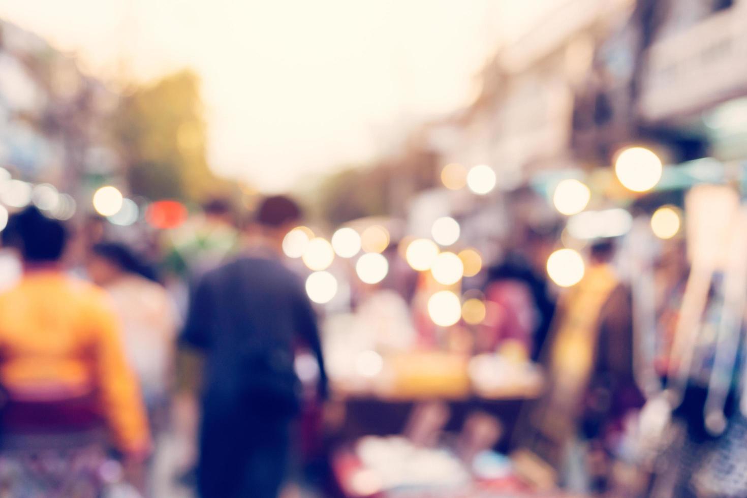 Blurred background. Blurred people walking through a city street. vintage toned photo. photo