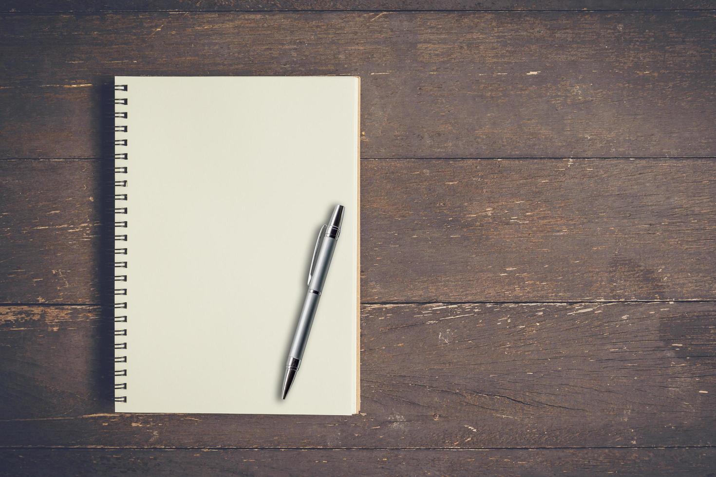 Blank notebook and on wood table with space. photo