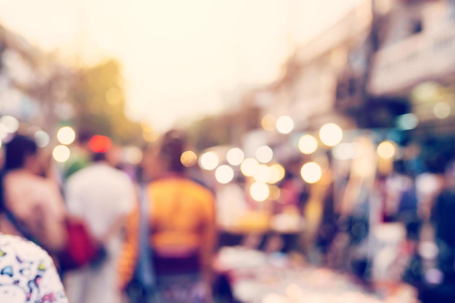Blurred background. Blurred people walking through a city street. vintage toned photo. photo