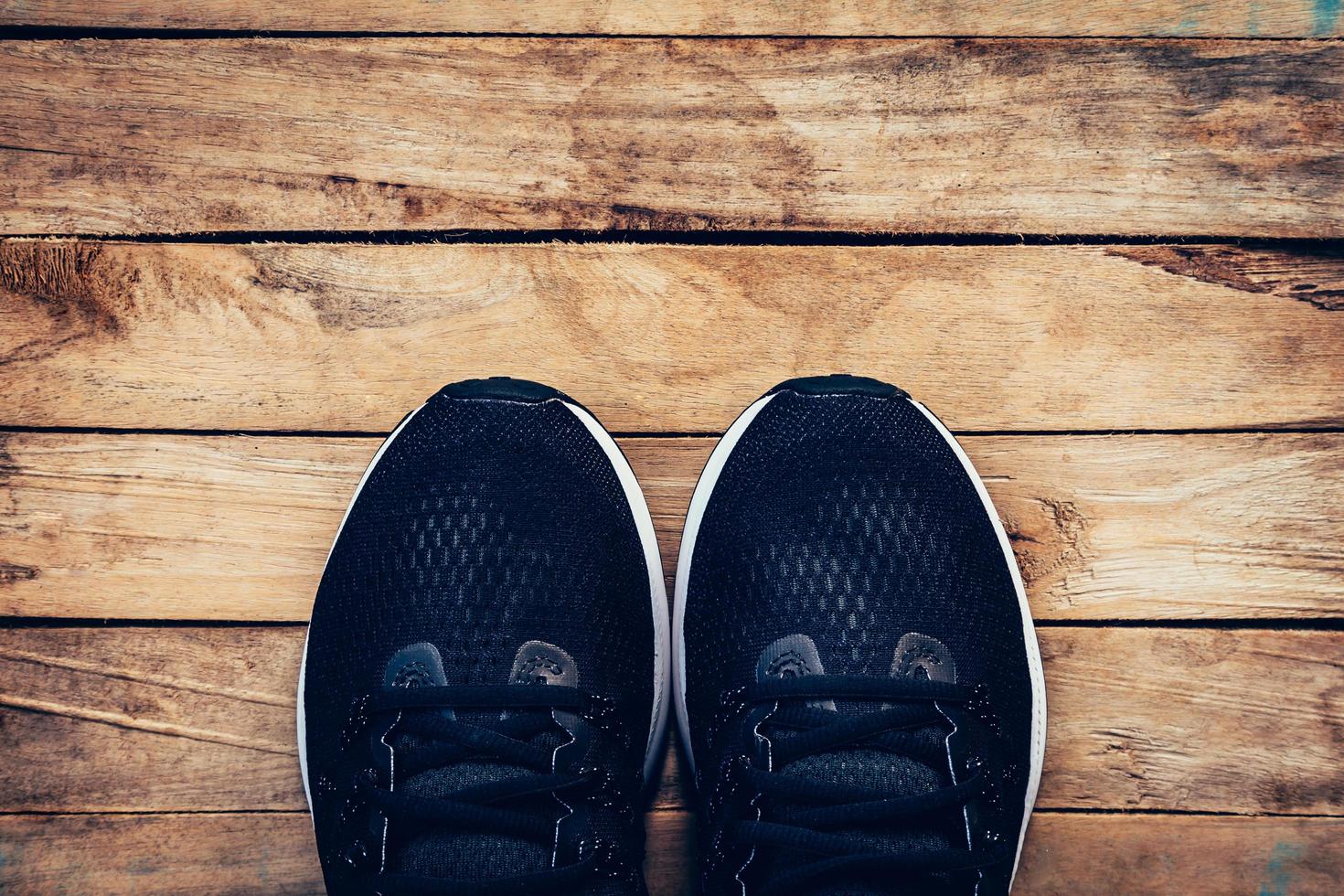 Black shoes casual and sneaker on wood background with space. photo