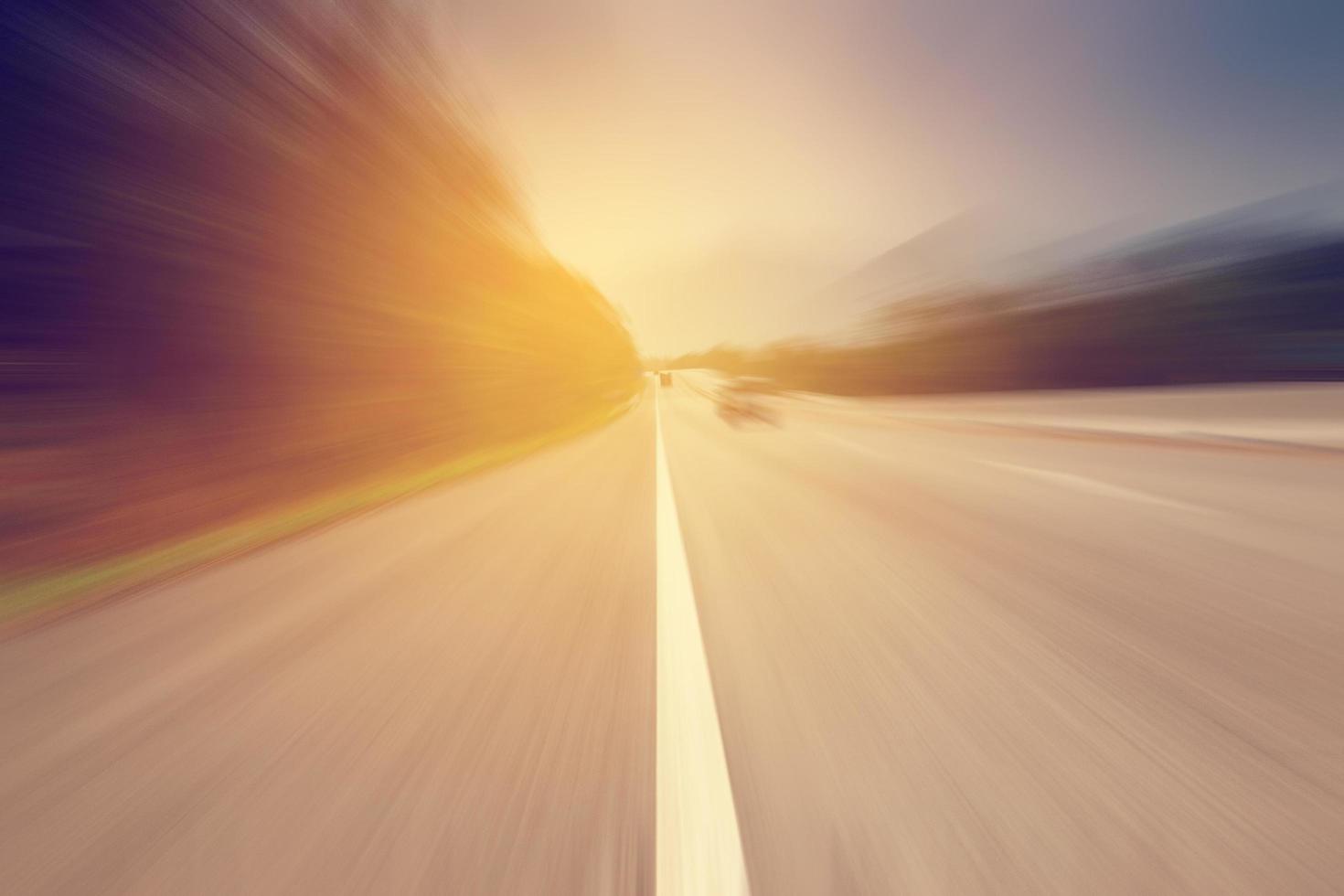 Abstract motion blurred road and sunlight with vintage tone. photo