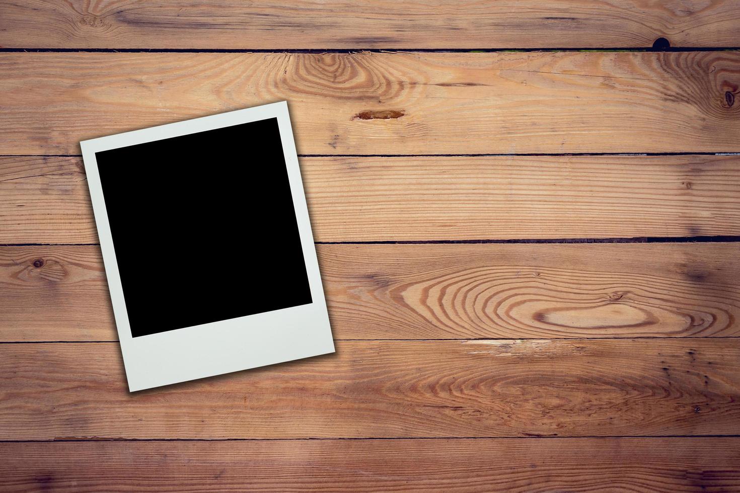 Blank photo frame on wood background and texture