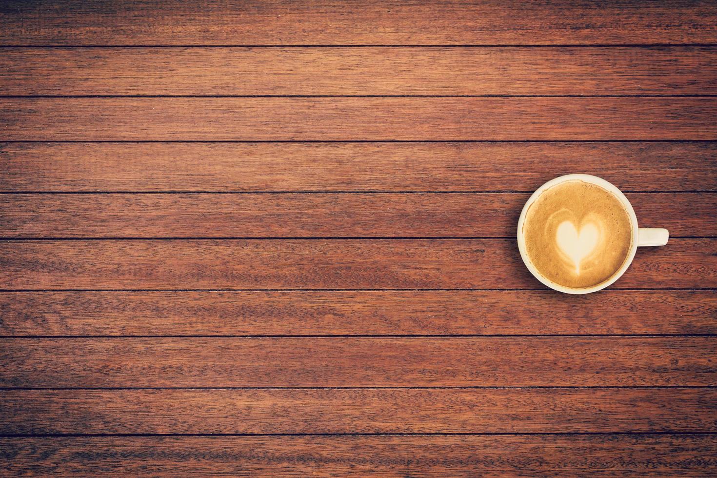 Latte coffee on table wood background with space photo