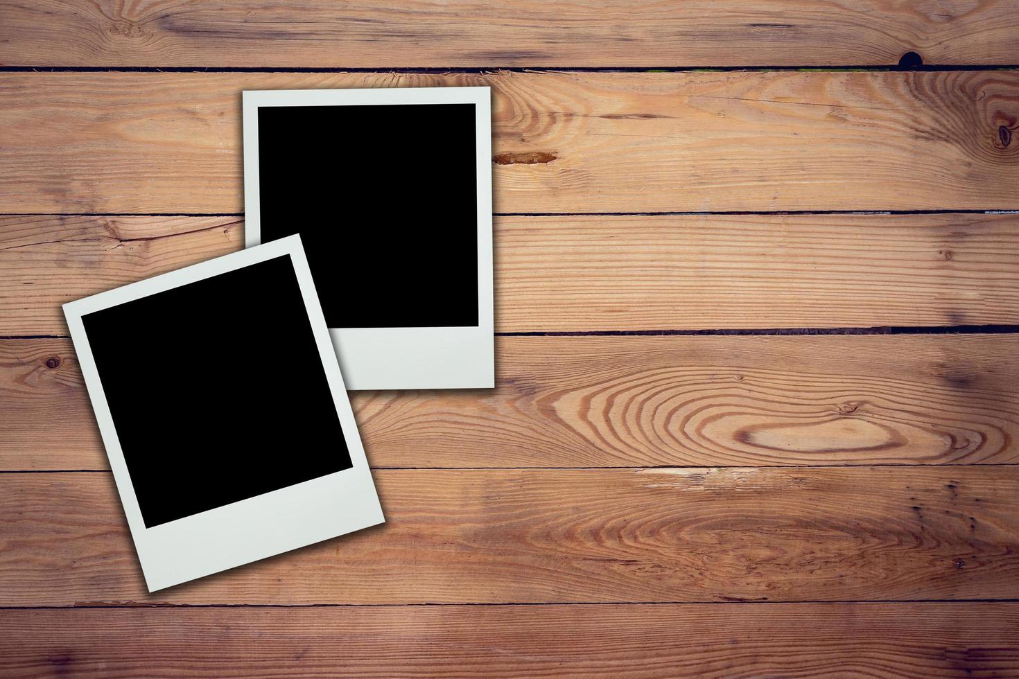 Blank photo frame on wood background and texture
