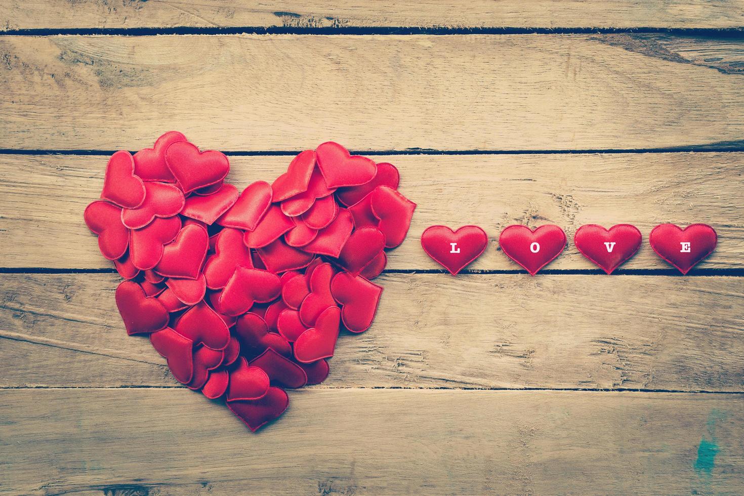 Small heart in a shape of a heart on wood for valentine background photo
