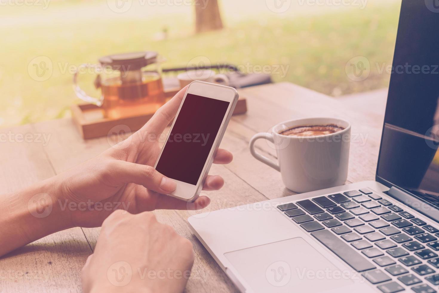 Young business man working in coffee shop with vintage filter. photo