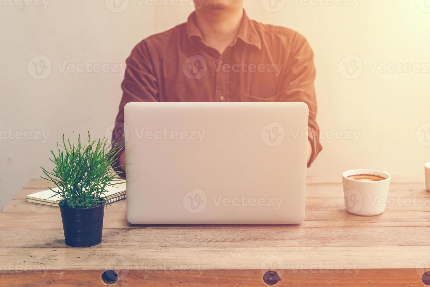 Young business man working in coffee shop with vintage filter. photo