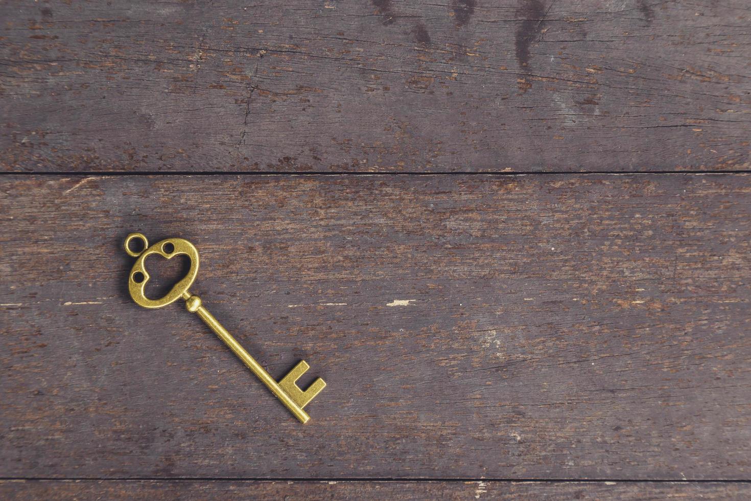 old key vintage on wooden background with space photo