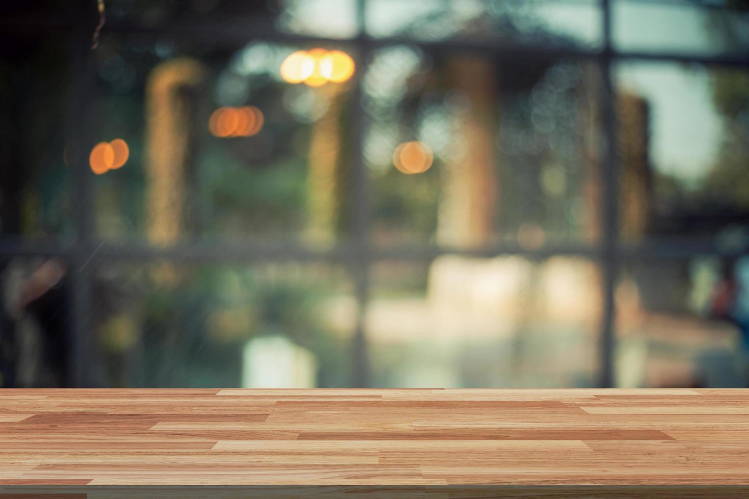 Empty wood table and Blurred background display at coffee shop with space for product. photo