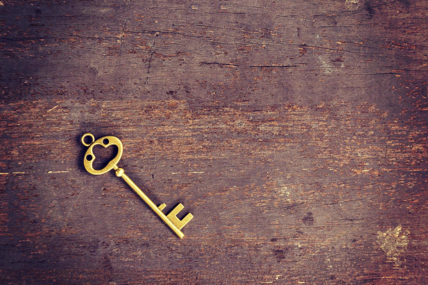 old key on wood background with space photo