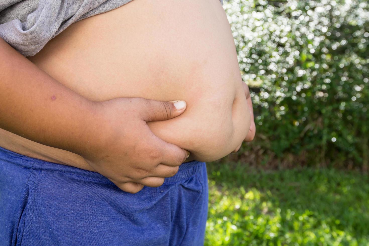 Boy fat and unhealthy with natural background. photo