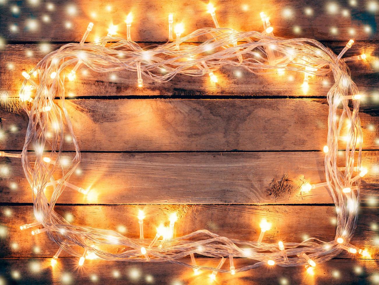 Christmas decoration background - vintage planked wood with lights and snow with copy space text. photo