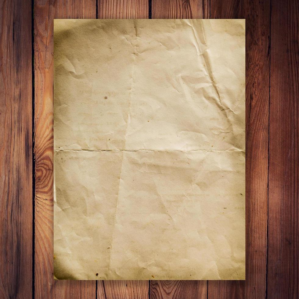 old paper on wood background and texture photo