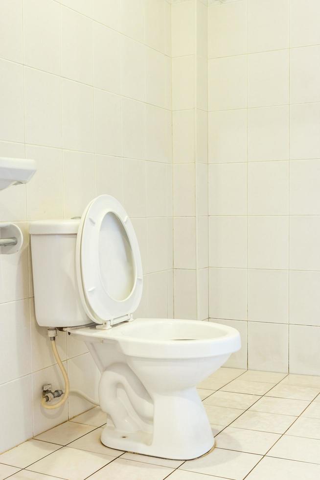 White toilet bowl in a bathroom photo
