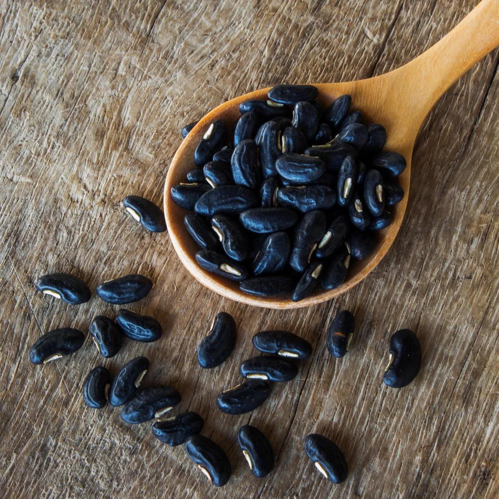 close up bean seed spoon on wood table photo