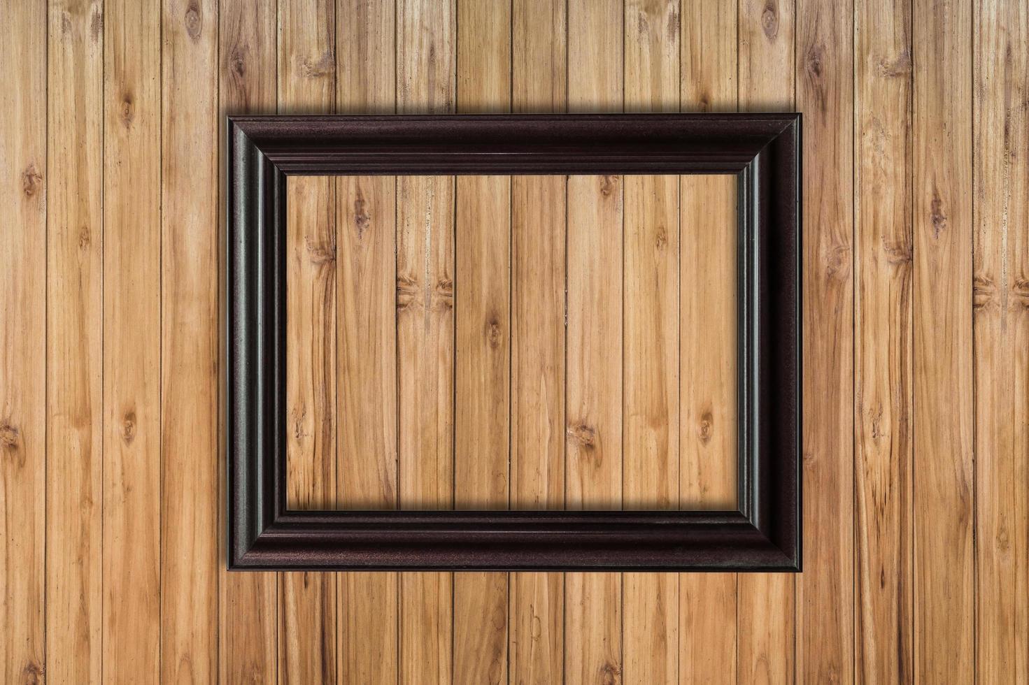 Picture frame on wood background with space photo