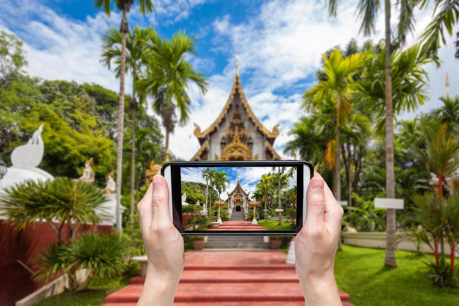 Hand taking photo at wat pha dara bhi rom Temple