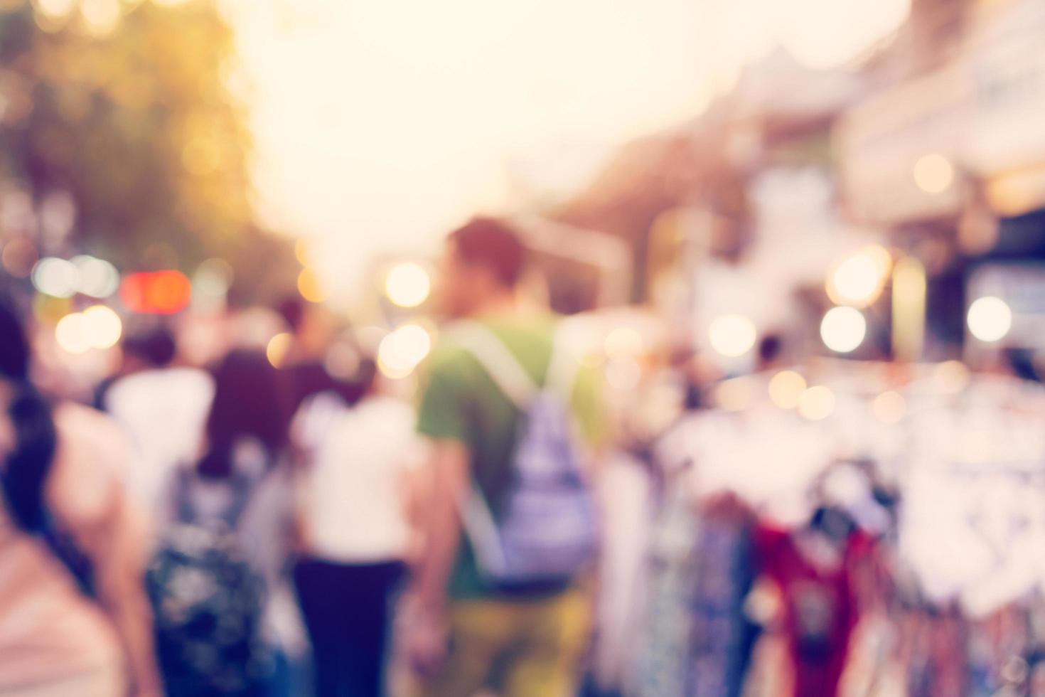 Blurred background. Blurred people walking through a city street. vintage toned photo. photo