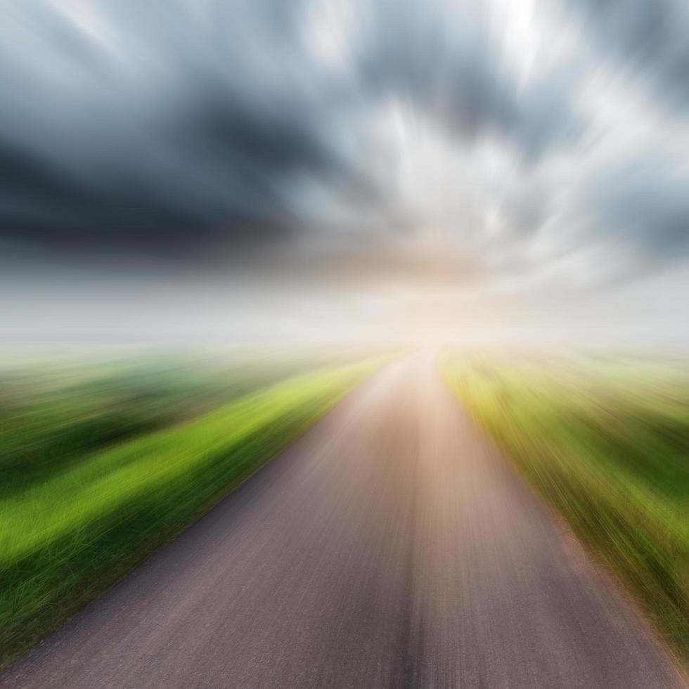 Country road on field and storm clouds or rainclouds photo