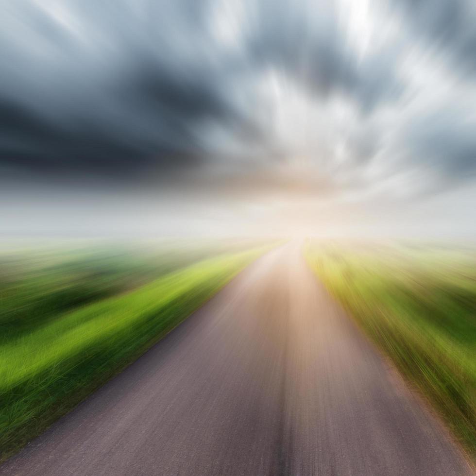 Country road on field and storm clouds or rainclouds photo