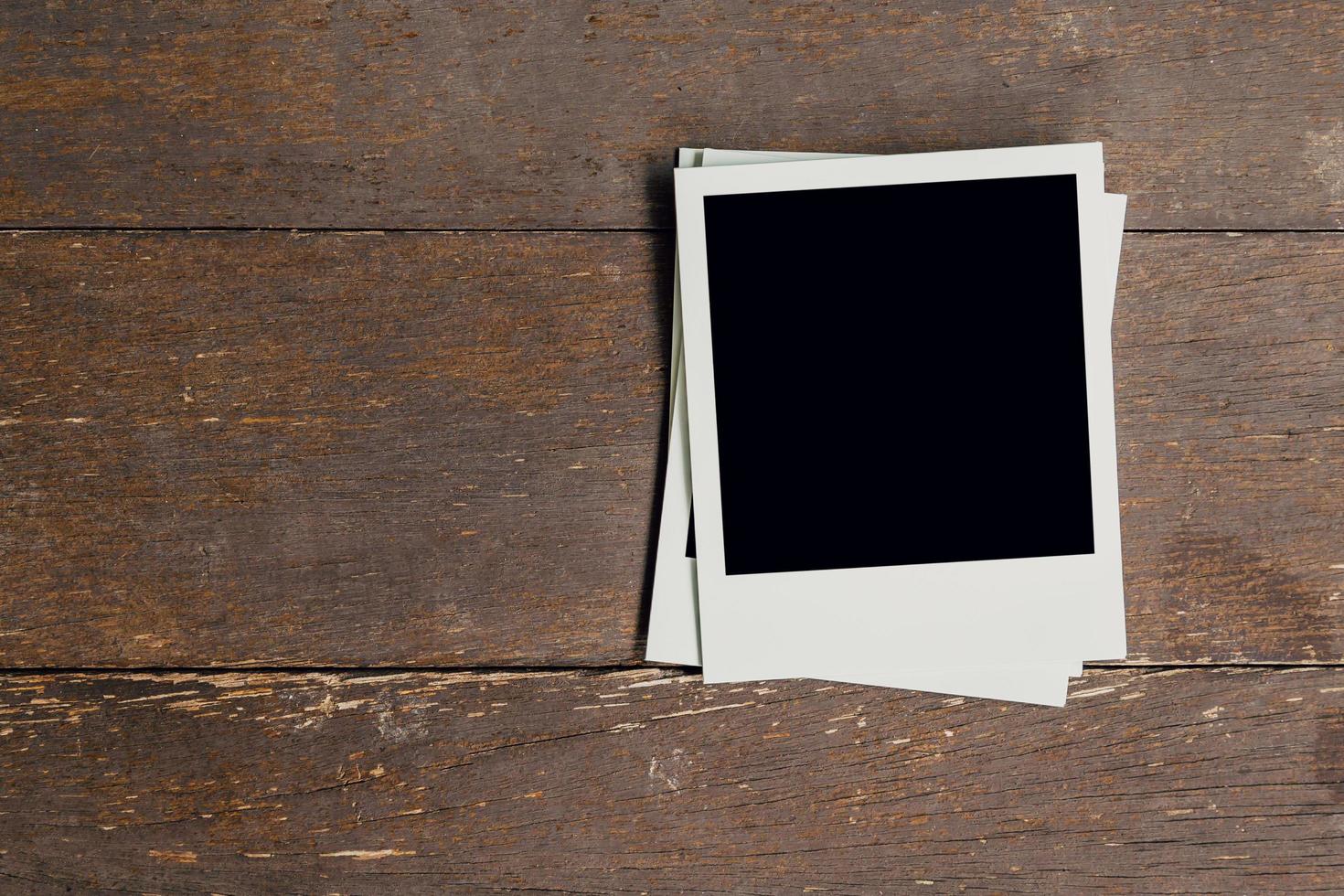 Vintage photo frame blank on old wood background with space