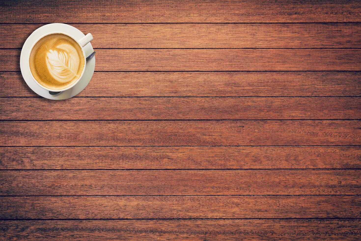 Coffee cup on wood texture and background with space. photo