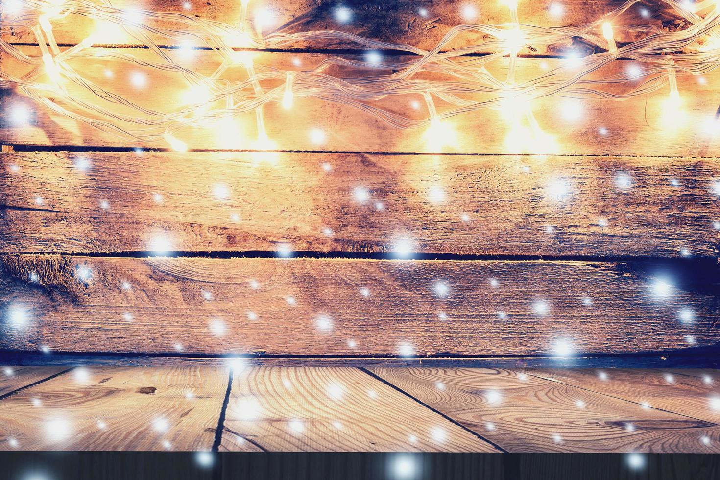 Christmas light on wooden background and wooden table, Vintage Christmas Decoration With Lights On Wooden Table, Christmas table background with space for product. photo