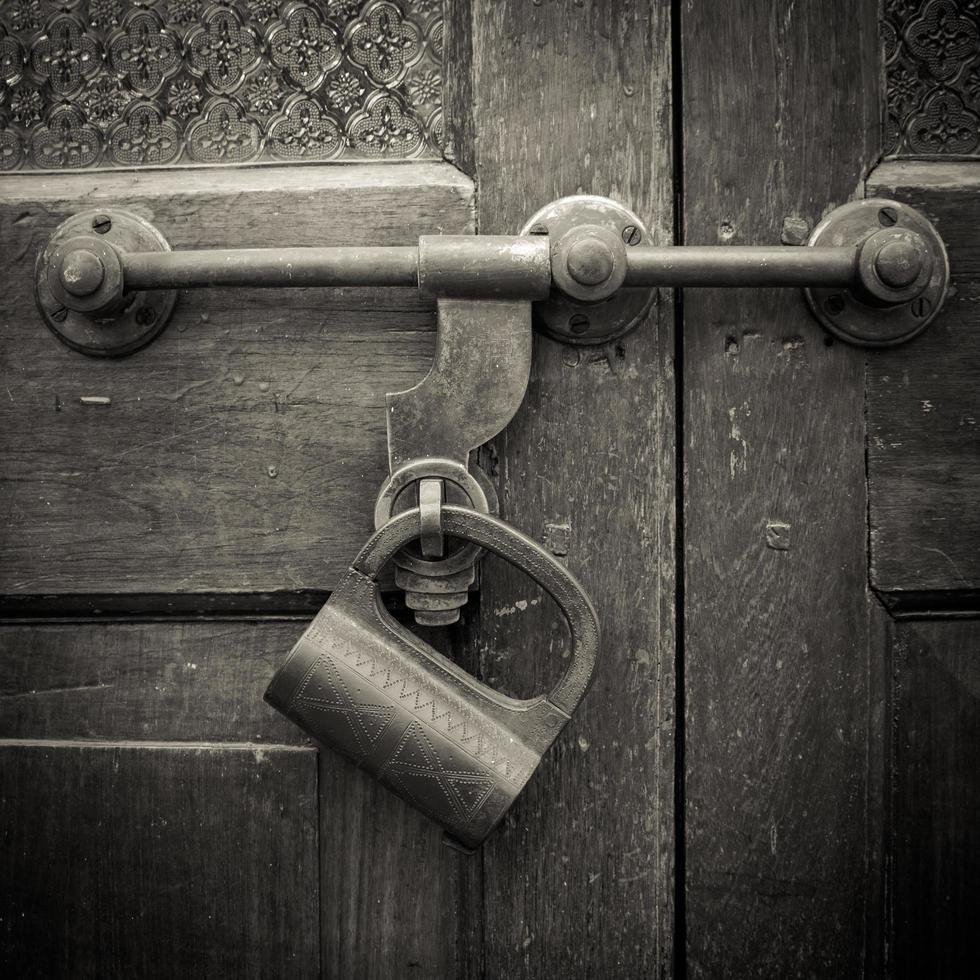 Closeup old door with lock in vintage style and wood texture. photo