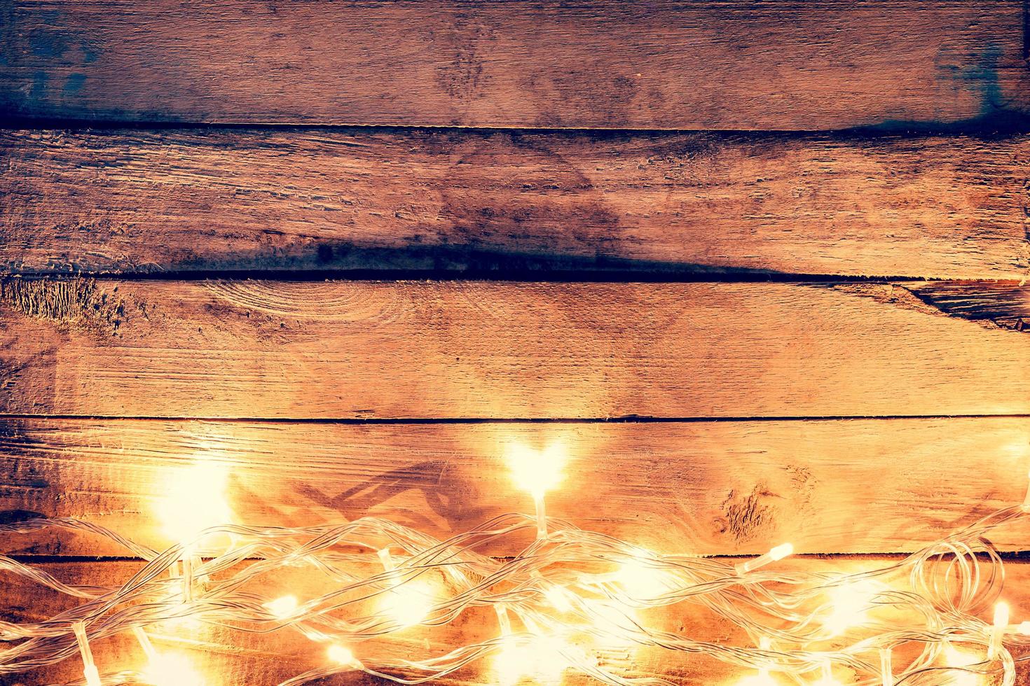 christmas light on wooden background with space photo