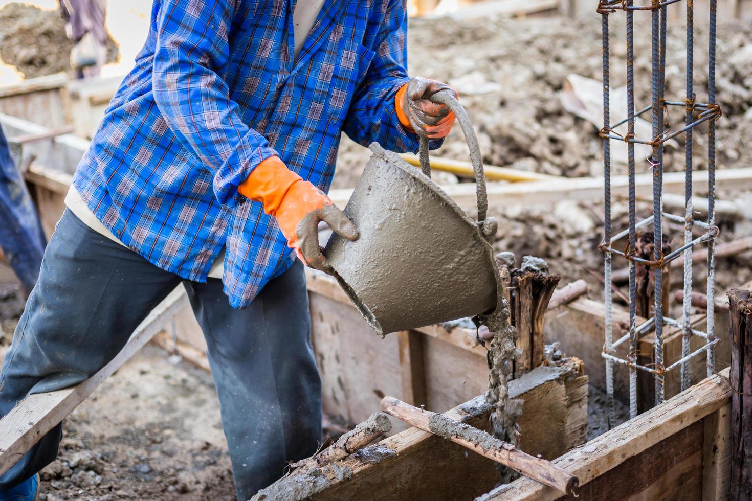 worker mixing cement mortar plaster for construction photo